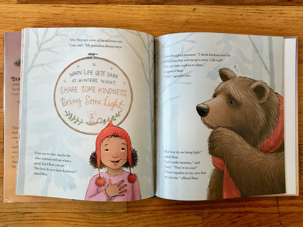 Coco remembering her grandma's quote stitched in an embroidery hoop while Bear looks thoughtful.