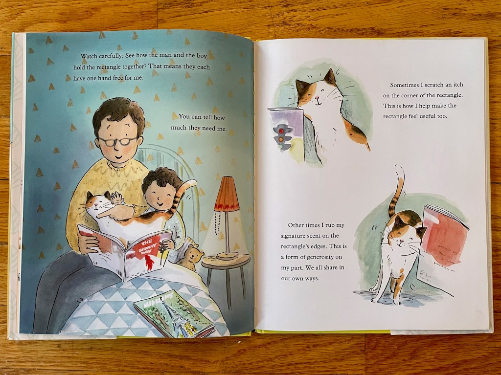 Dad and boy reading while the cat sneaks in and rubs on the edges of the book (rectangle).