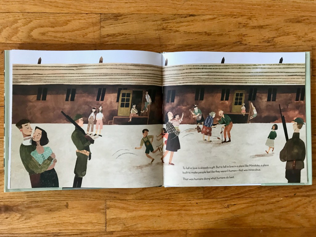 A long building fills the span of the spread. Two guards stand around the edges of the page. People keep busy in the middle talking, dancing, playing tag, sweeping, and just sitting and being. George and Tama stand together in the bottom left corner with George's arms around Tama and they are looking at each other.