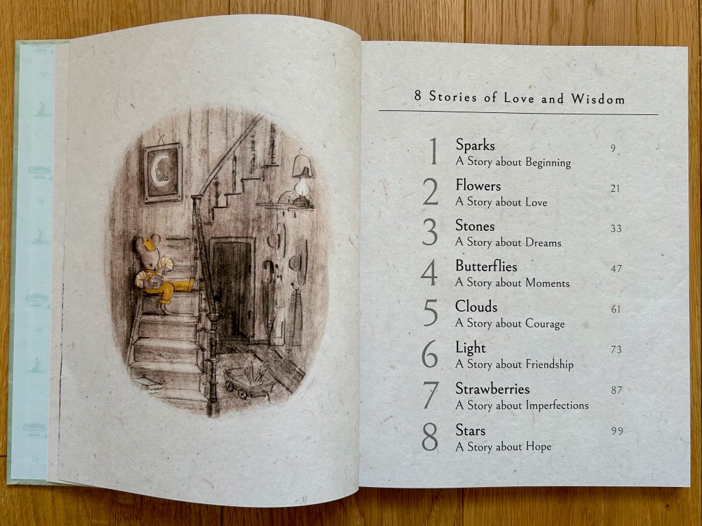 Oval illustration on the left page of a little bear in yellow overalls sitting on a staircase playing with a Rubik's cube. The right page lists the table of contents for stories in the book.