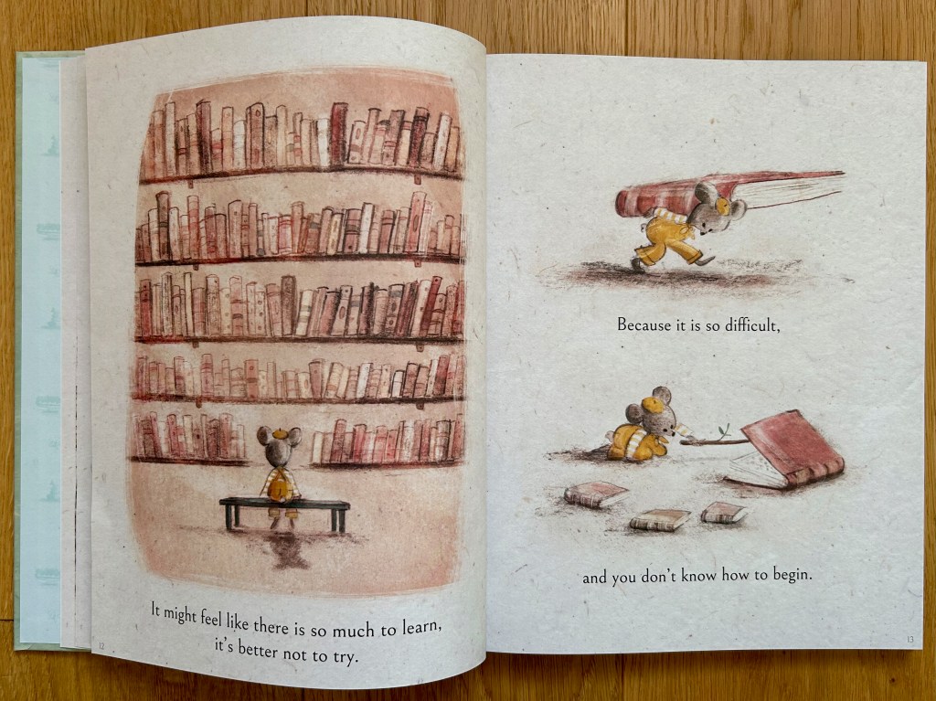 The little bear sits before a giant wall of books on the left. On the right, two vignettes show the bear struggling to carry a very large book and then peeking inside the book cautiously.